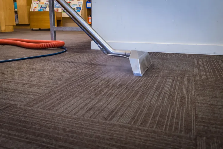 Tile cleaning technician deep-cleaning tiled floors with professional equipment
